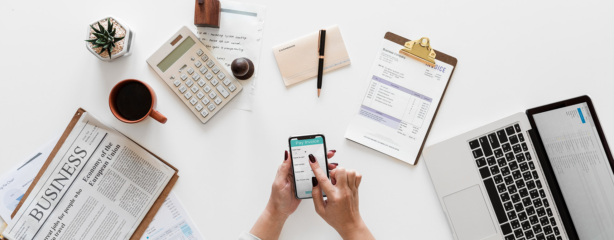 Business records and calculator arranged on a desk