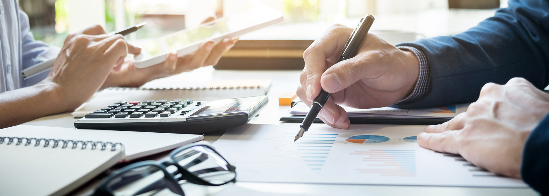 People reviewing financial figures together at a desk