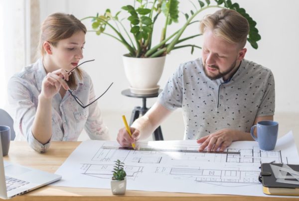 Man and woman at table looking at documents